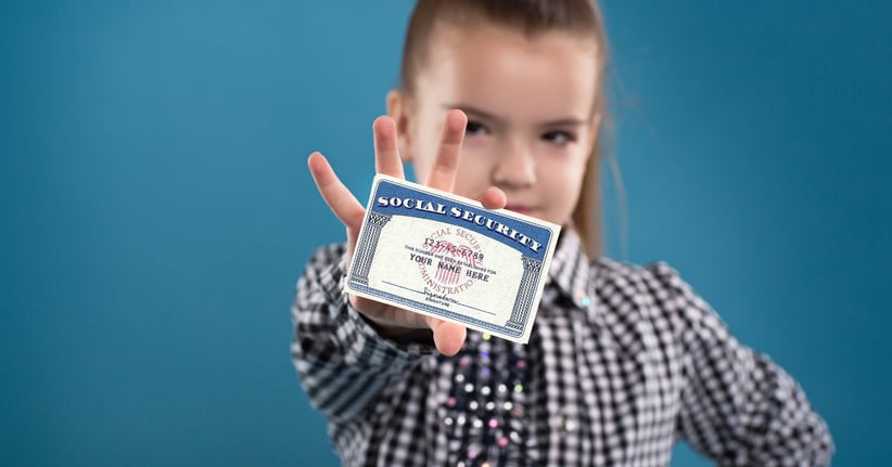 small girl holding a social security card